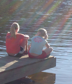 Students sit on a dock.