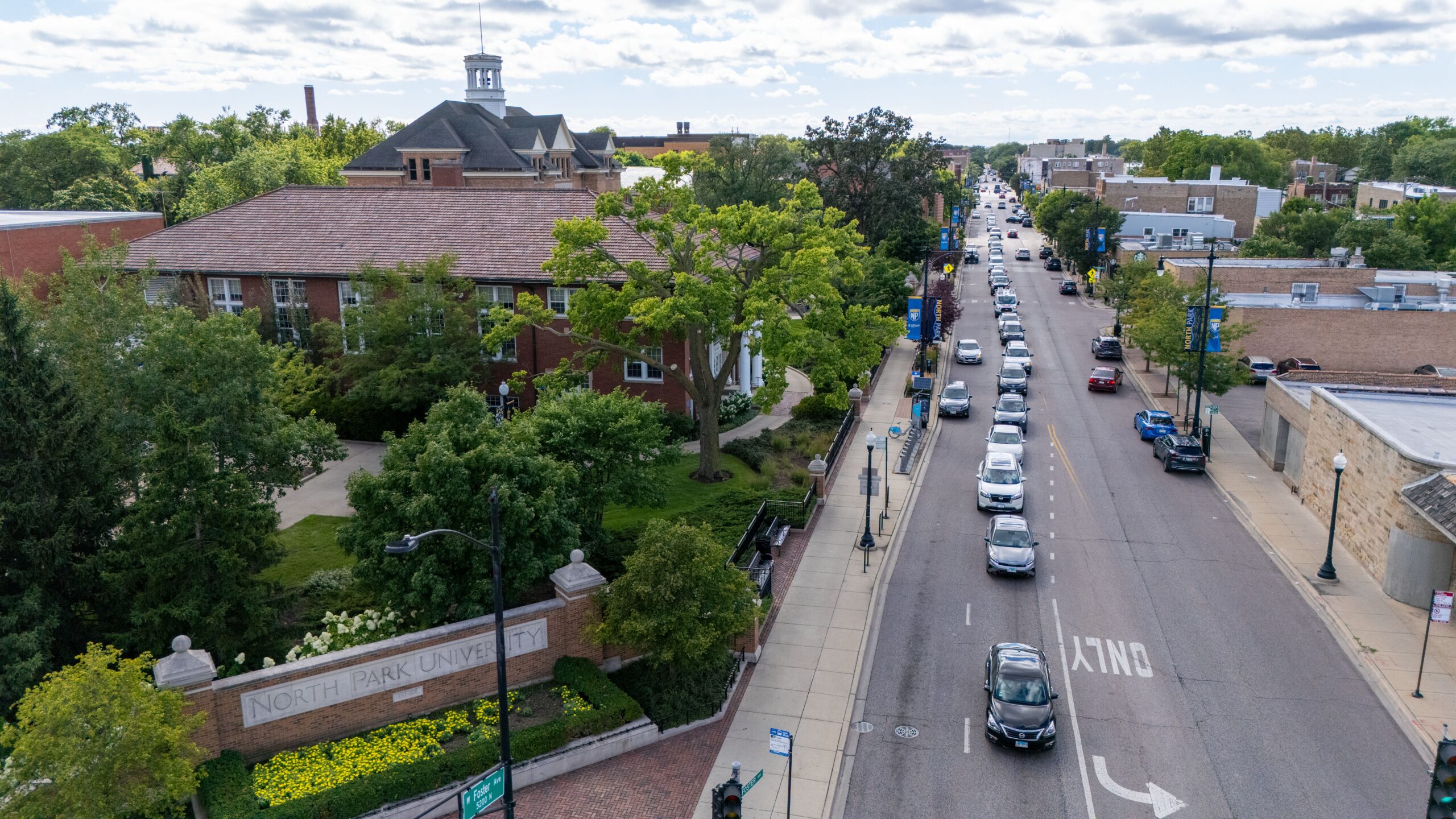Aerial view of North Park University's campus along Foster Avenue, with the neighborhood businesses in view.