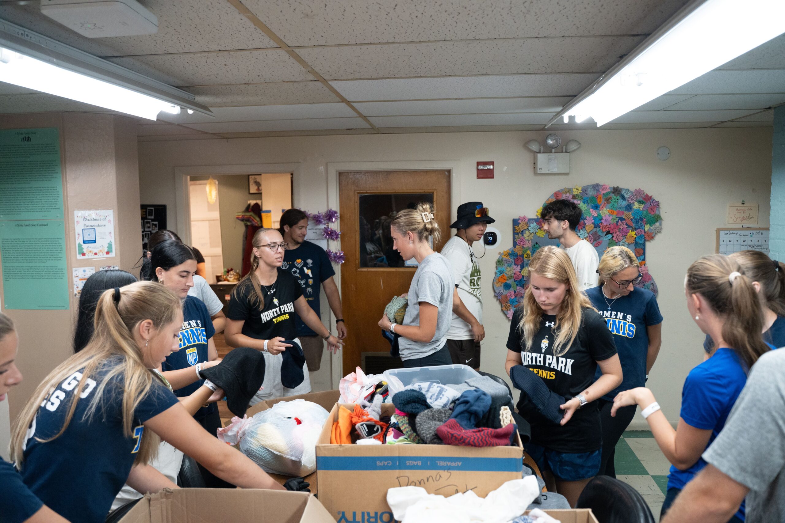 Students sort through clothing donations as part of a Service Day event
