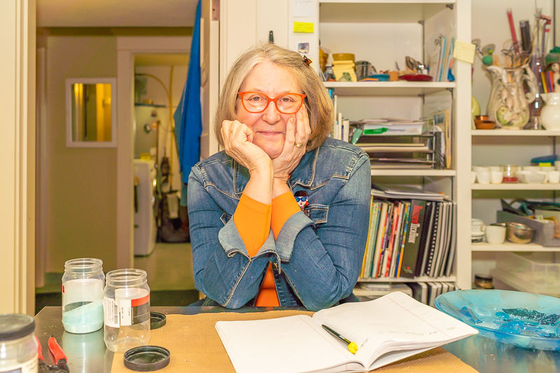 North Park University alumna Kerstin Hilton posing at a desk with an office background.