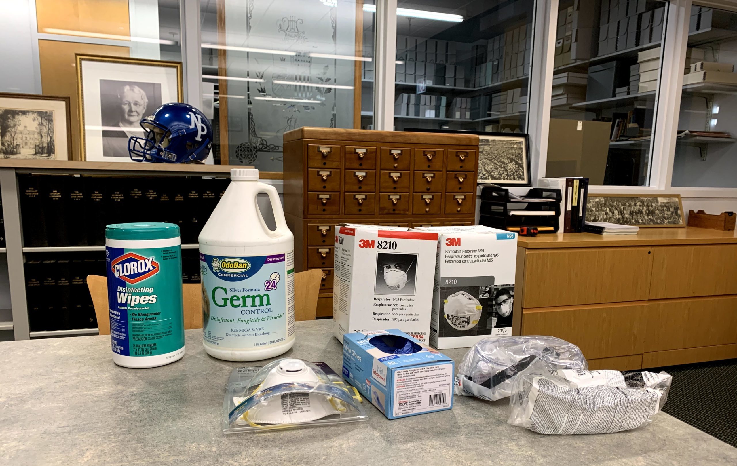 Personal protective equipment lined up on table in the archives.